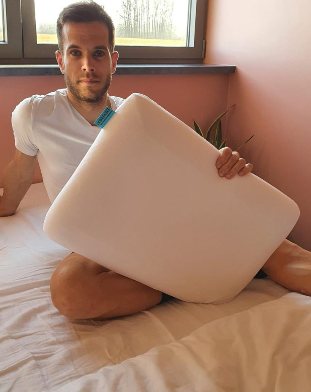 Hans Becking holding a levitex pillow