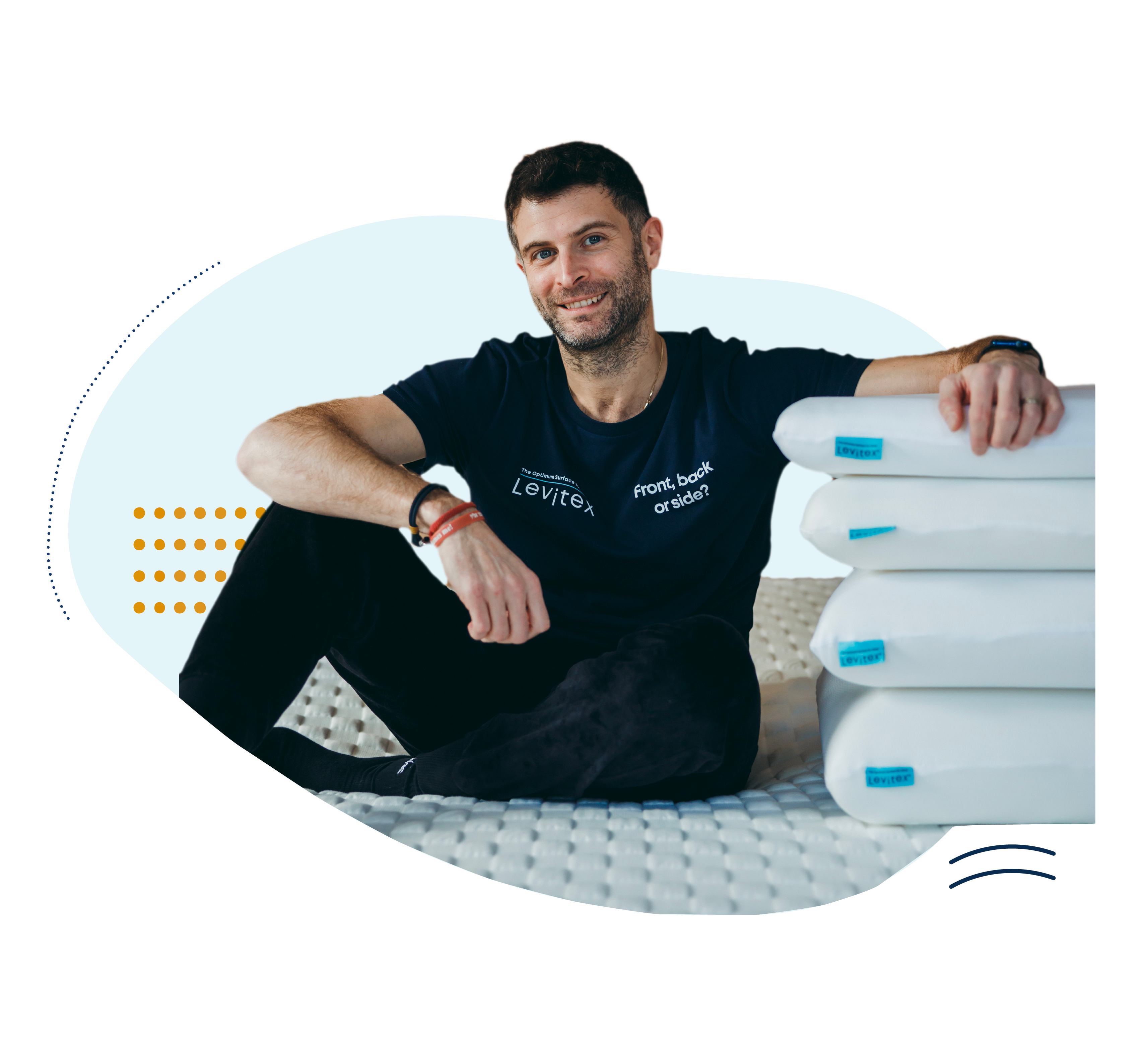 James Leinhardt on bed next to 4 stacked levitex pillows