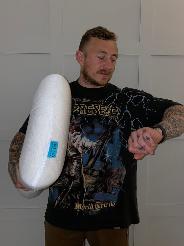 Joshua Charnley holding a levitex pillow