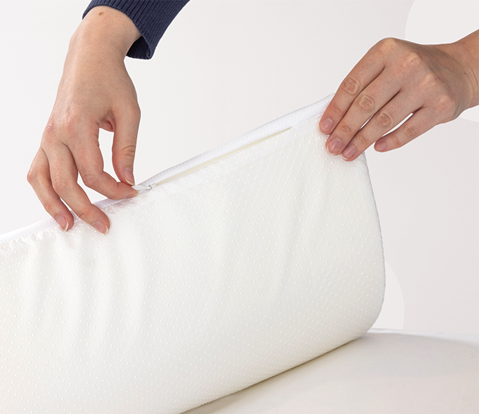 Person opening a white foam slice with a zipper on a white background