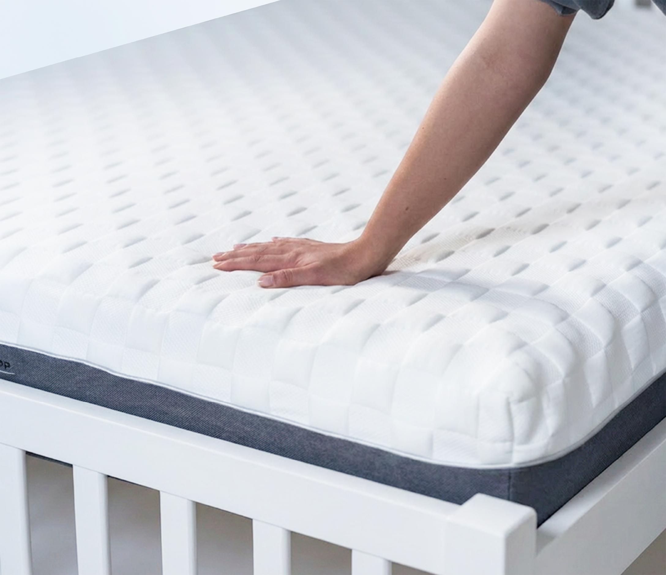 Mattress for posture on a bed with a hand touching it