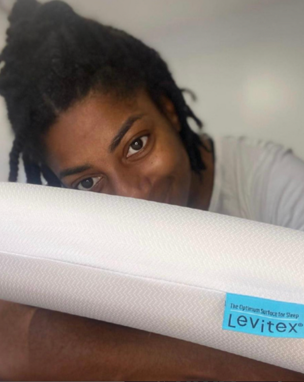 kadeena cox holding a levitex pillow