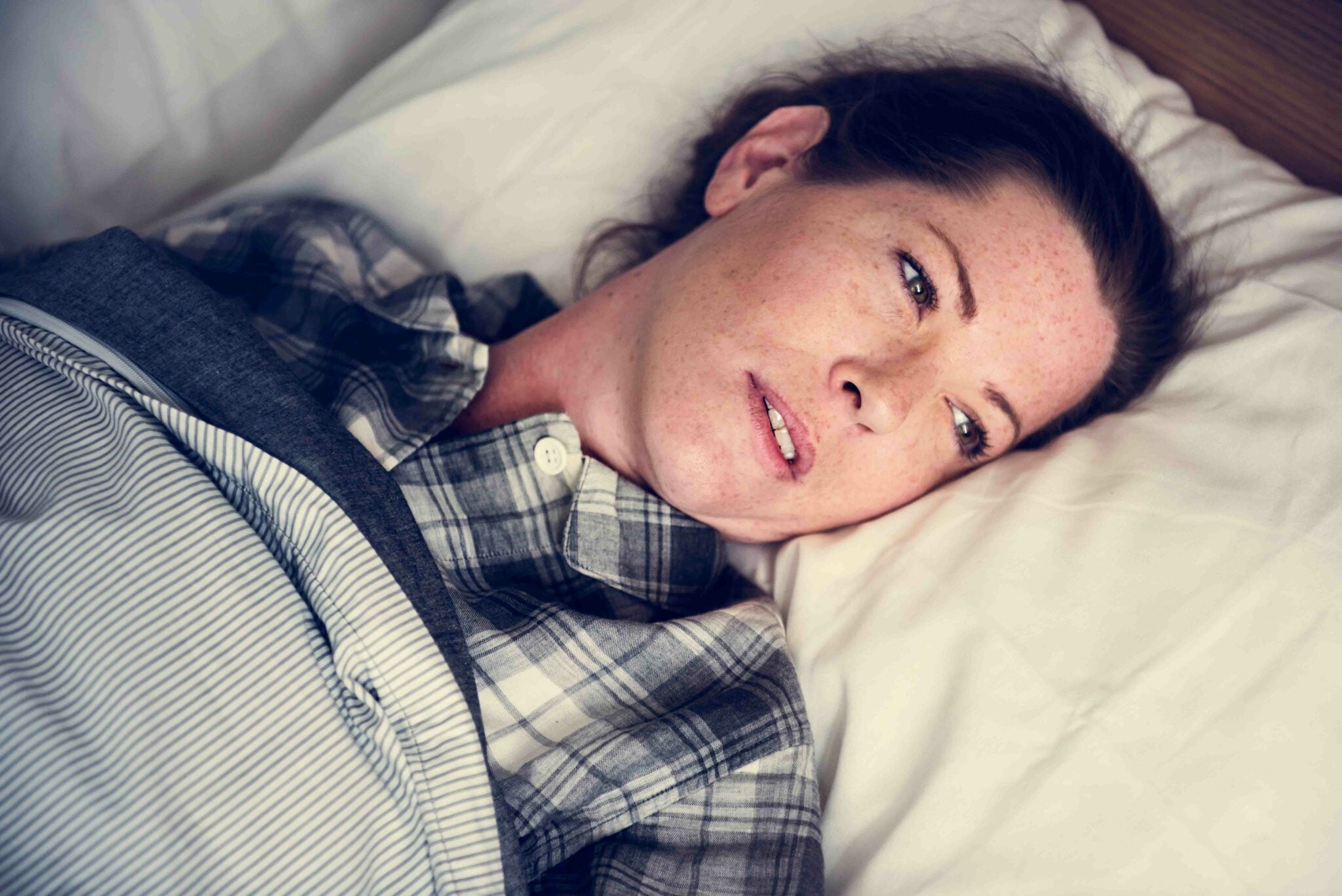 Woman lying awake in bed