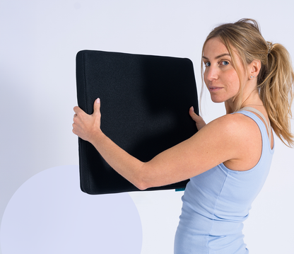 woman holding the seat topper in front of her while being turned to the camera
