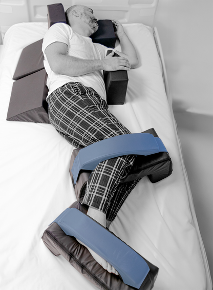 Person lying on a medical device with adjustable straps in a clinical setting