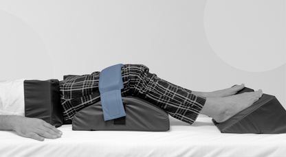 Person's legs using legs support straps and knee blockers for leg elevation on a white background