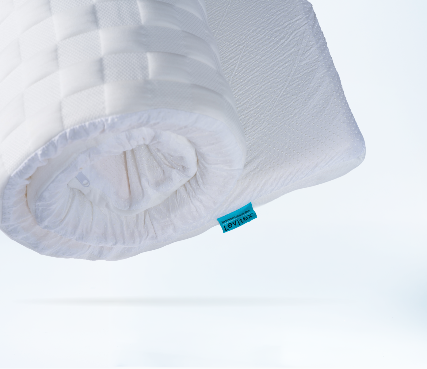 close up of a rolled mattress topper