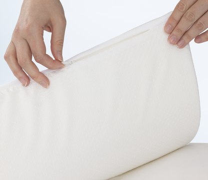 Close-up of a person holding a white pillow topper 